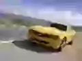 Yellow Chevrolet Camaro flies on road