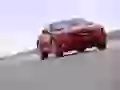 Red Chevrolet Camaro on road