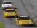 Two yellow Chevrolet Corvette on a racing line