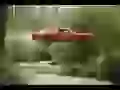 Red Dodge Charger flies to a channel
