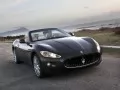 open picture: «Maserati GranCabrio on road along the sea»