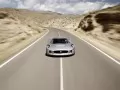 обои для рабочего стола: «Серебристый Jaguar C-X75 Concept мчится по дороге»