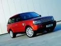 Red Land Rover Range Rover Sport at a light wall