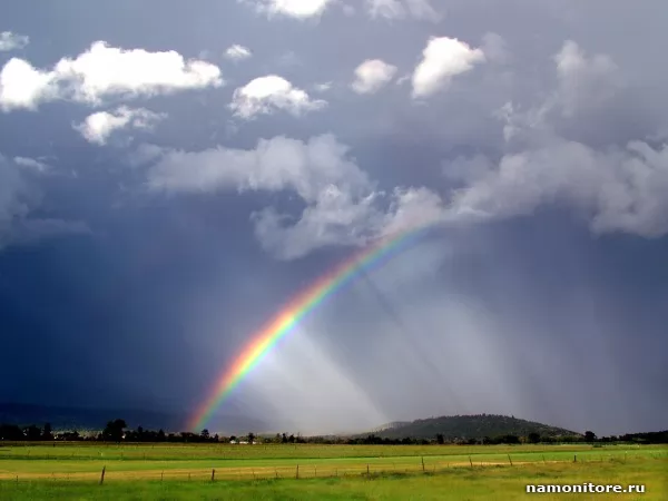 After a thunder-storm. A rainbow over a green field, Summer