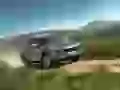 Porsche Cayenne S flies on a country road