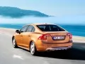 open picture: «Orange Volvo S60 rushes on road»