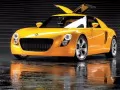 выбранное изображение: «Жёлтый Volkswagen Ecoracer-Concept с открывающимися вверх дверями»