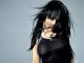 open picture: «Dark-haired Christina Aguilera in black on a grey background»