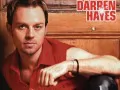 open picture: «Darren Hayes in a red shirt on a brown background»