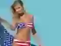 Joanna Krupa in a bathing suit in the form of the American flag